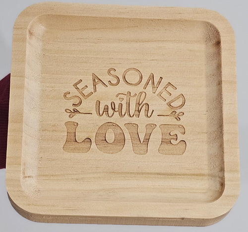 photo of Wooden tray with 'Seasoned with Love' engraving on a light background